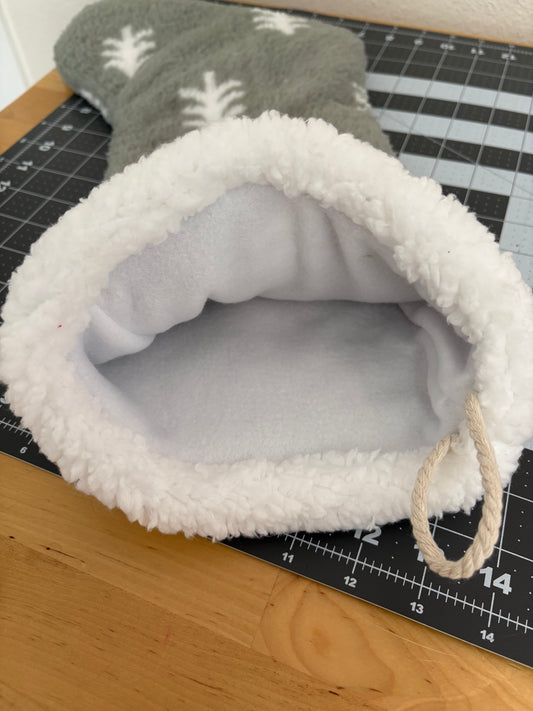 Gray stocking with white fleece lining on a cutting mat